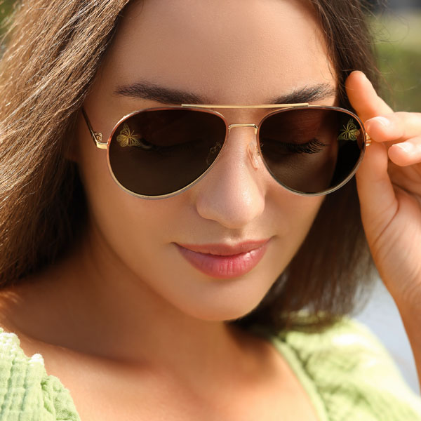 woman wearing sun glasses with a SpecTats Butterflies design