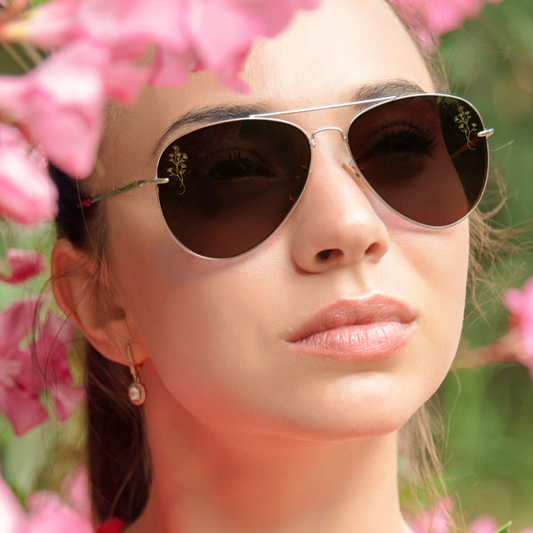 woman wearing sun glasses with a SpecTats Floral Flourish design