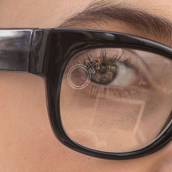 Close up of a woman wearing clear glasses with a SpecTats Gender Symbol design