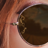 Close up of a woman wearing sun glasses with a SpecTats Heart Flourish design