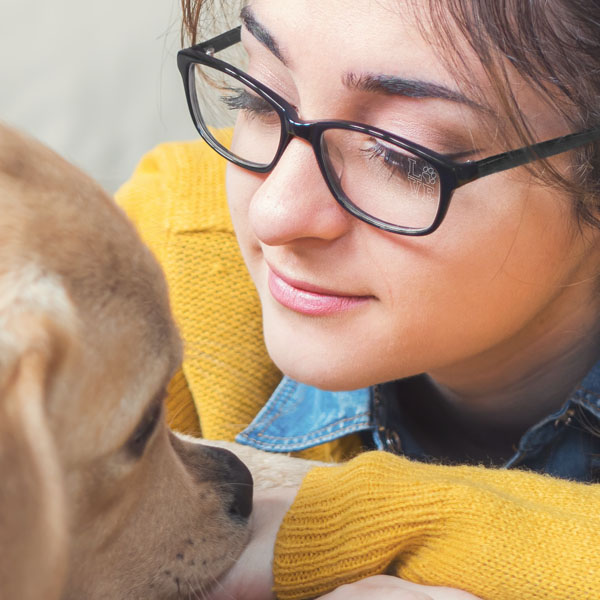 woman wearing clear glasses with Paws n' Claws SpecTats design