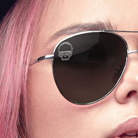 Close up of a woman wearing gray polarized sunglasses with a SpecTats Skull design