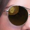 Close up of a woman wearing gray polarized sunglasses with a SpecTats Sugar Skull design