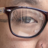 Close up of a man wearing clear glasses with a SpecTats Symbol Basics design