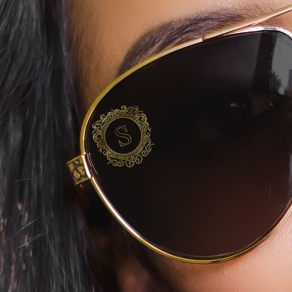 Close up of a woman wearing brown polarized sunglasses with a Vintage Letter SpecTats design in Copper Blush finish